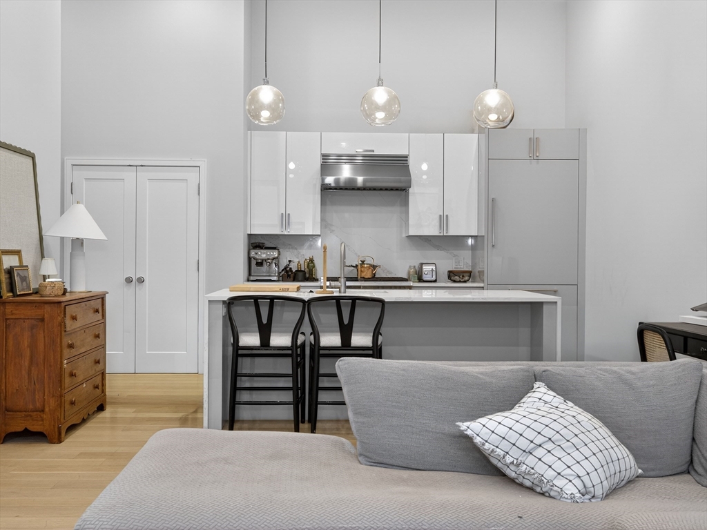 355 Congress Street, Unit 501 Boston, MA 02210 - Photo 4 of 16 a living room with furniture and a fireplace