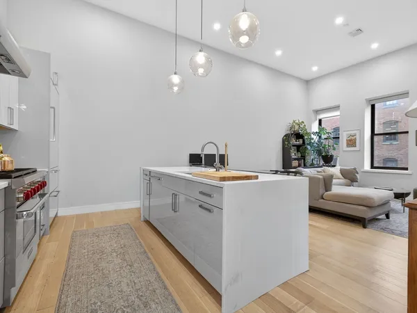 a view of living room with furniture and wooden floor