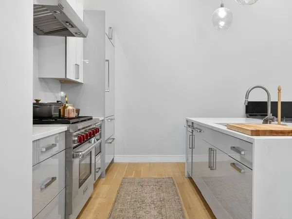 a kitchen with stainless steel appliances a stove a sink and a refrigerator