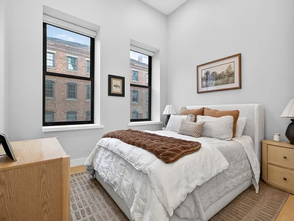 a bedroom with bed and wall painting with wooden floor