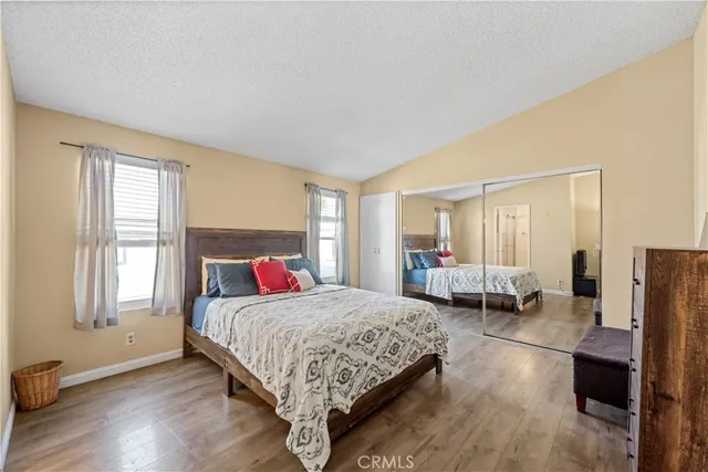 a bedroom with a bed couch and a window