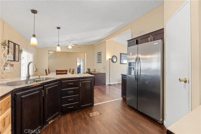 a kitchen with a refrigerator and a sink