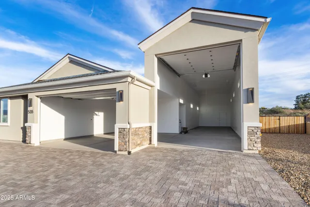 a view of a city with large trees next to a road