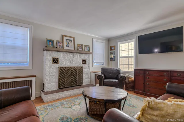 a living room with furniture a flat screen tv and a fireplace