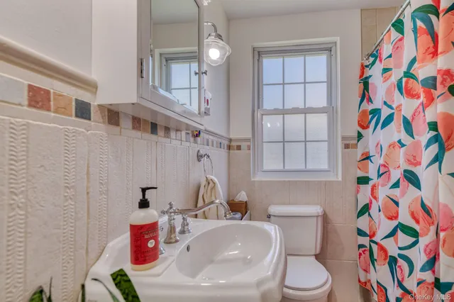 a living room with furniture and dresser