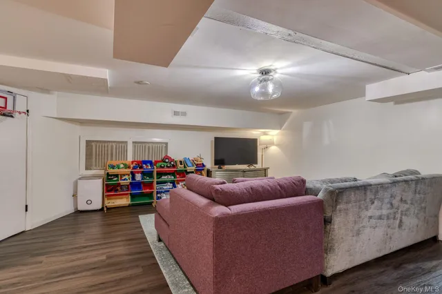 a living room with furniture a couch and a flat screen tv