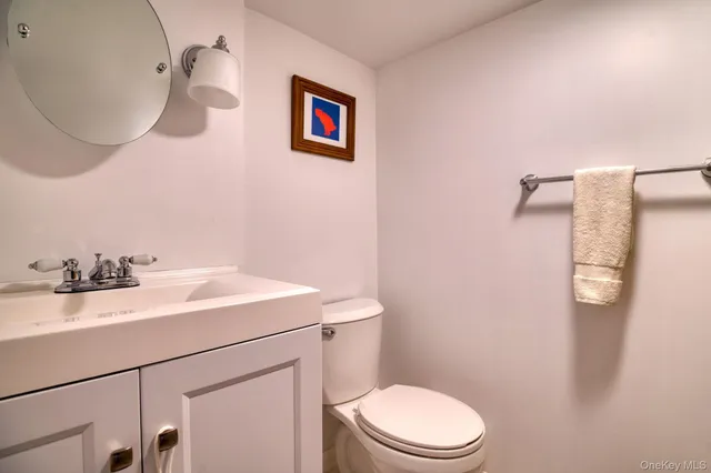 a spacious bedroom with a bed a dresser and a chandelier