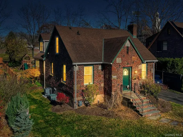 a kitchen with granite countertop a sink stove and white cabinets