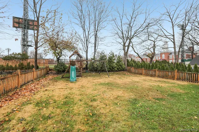 a view of a house with a yard and sitting area