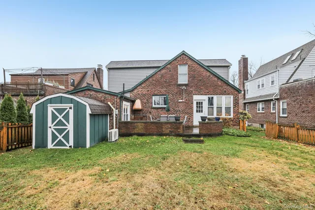a front view of a house with yard and green space