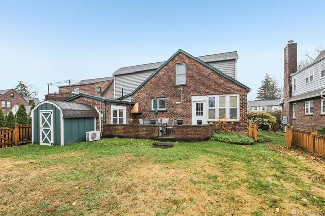 a view of a backyard with a tree