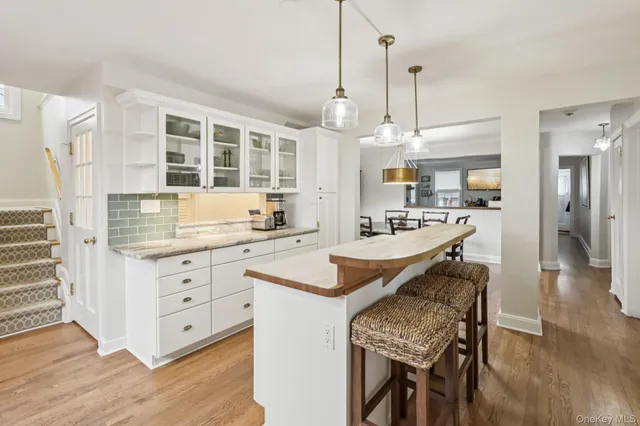 a kitchen with stainless steel appliances a stove cabinets and wooden floor