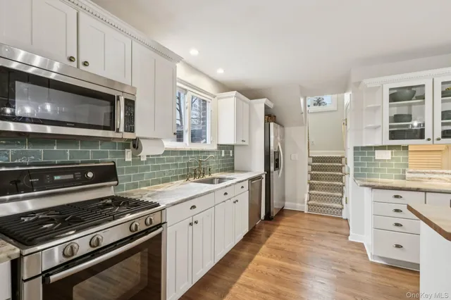 a kitchen with a stove a sink and a refrigerator