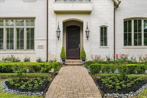 a front view of a house with garden