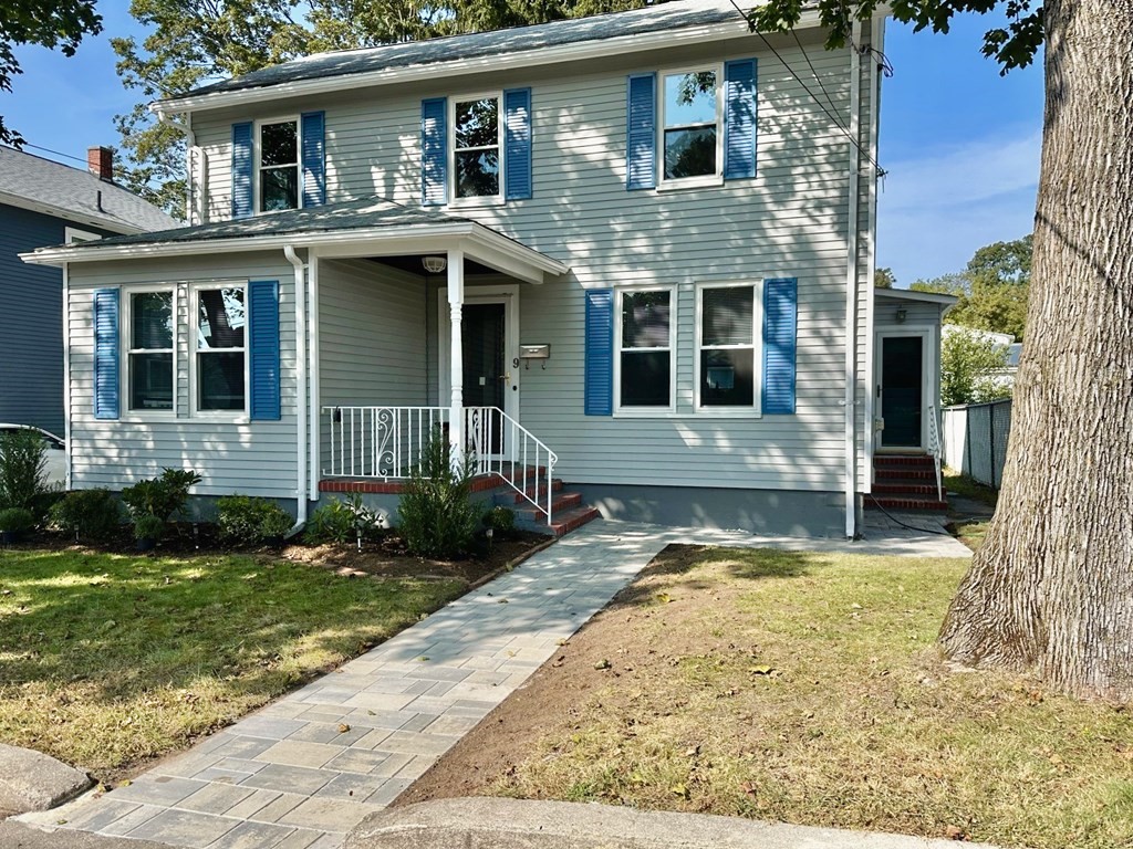 a view of a house with a yard in front of it
