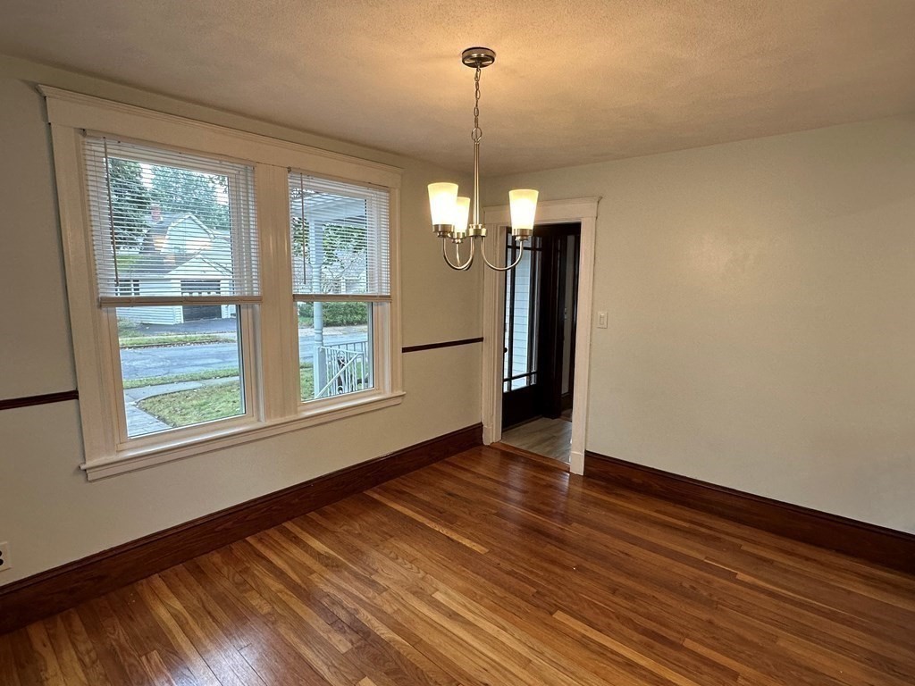 9 Upland Road Winchester, MA 01890 - Photo 13 of 42 a view of an empty room with wooden floor and a window