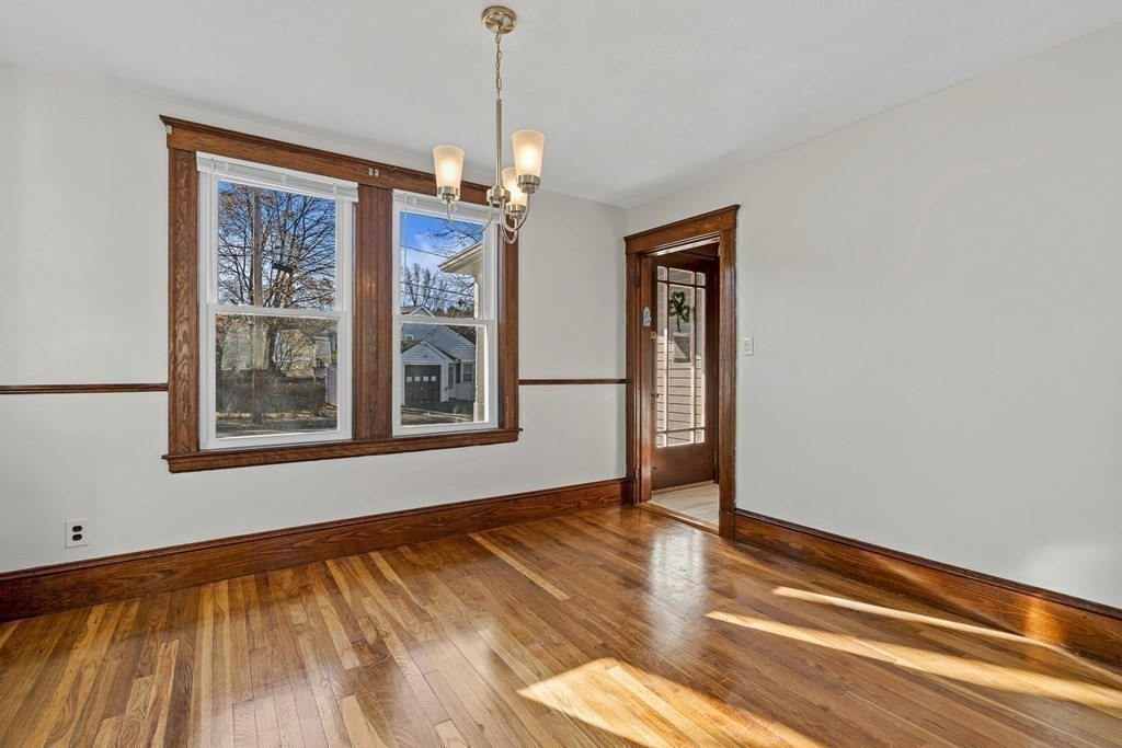 9 Upland Road Winchester, MA 01890 - Photo 15 of 42 a view of an empty room with wooden floor and a window