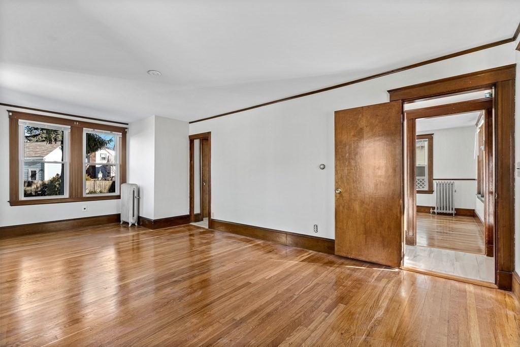 9 Upland Road Winchester, MA 01890 - Photo 18 of 42 an empty room with wooden floor and a fireplace