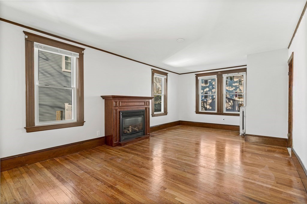 9 Upland Road Winchester, MA 01890 - Photo 19 of 42 an empty room with windows and fireplace