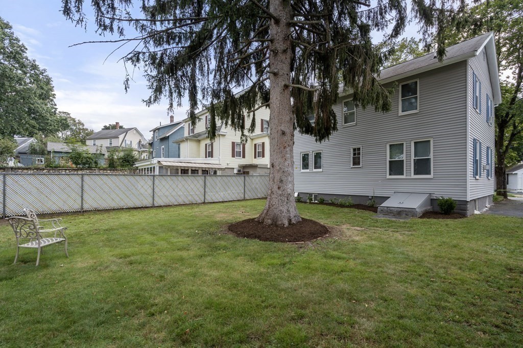 9 Upland Road Winchester, MA 01890 - Photo 35 of 42 a backyard of a house with table and chairs