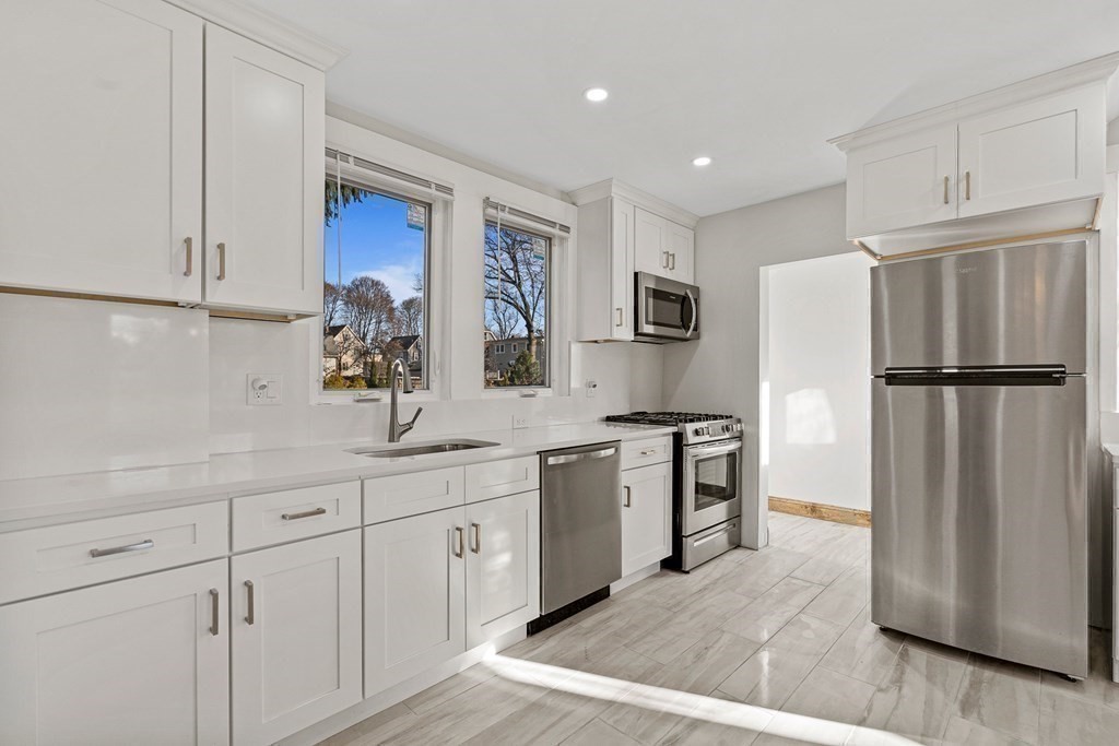 9 Upland Road Winchester, MA 01890 - Photo 6 of 42 a kitchen with stainless steel appliances granite countertop a refrigerator sink and stove