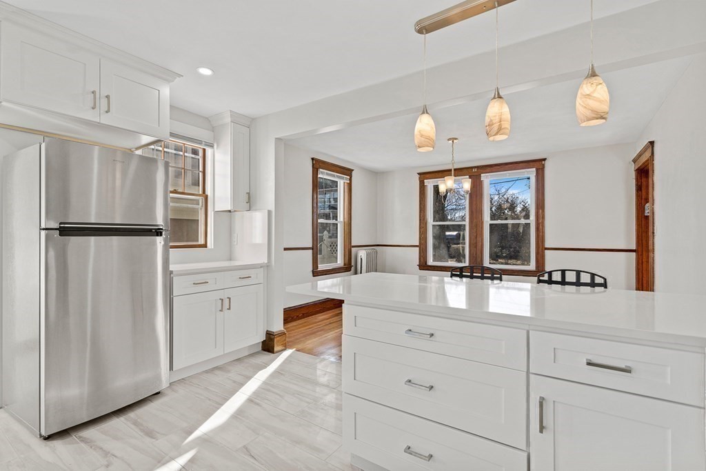 9 Upland Road Winchester, MA 01890 - Photo 9 of 42 a kitchen with white cabinets and stainless steel appliances