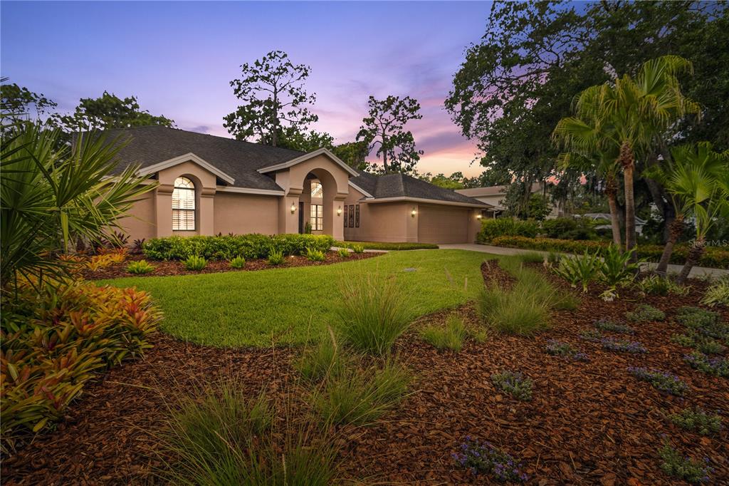 3372 Brian Road South Palm Harbor, FL 34685 - Photo 1 of 45 a front view of a house with a garden