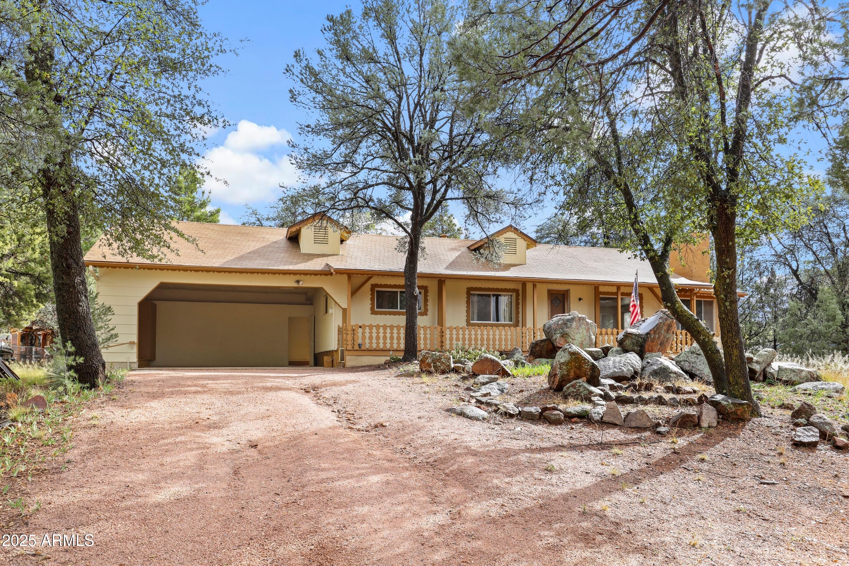 413 East Idle Circle Payson, AZ 85541 - Photo 1 of 24 a front view of a house with garden