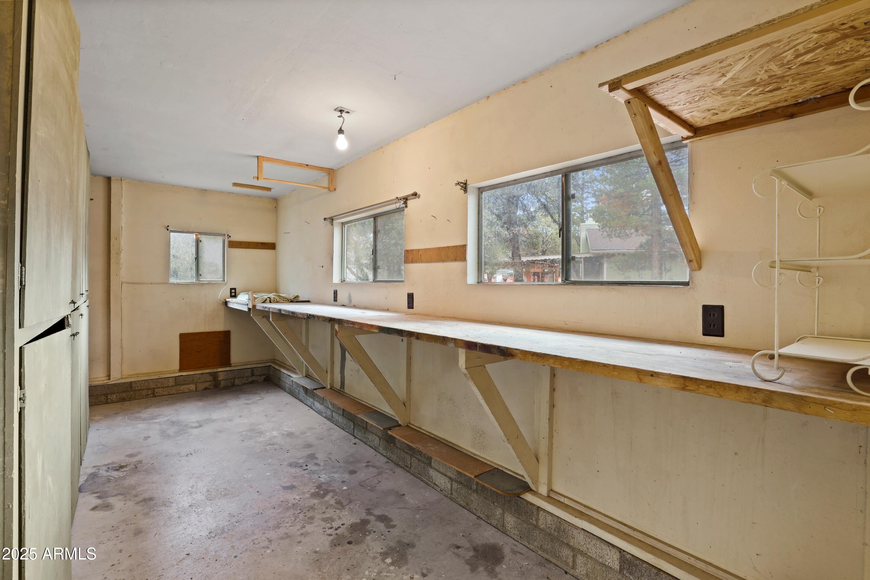 413 East Idle Circle Payson, AZ 85541 - Photo 17 of 24 a large white kitchen with a sink and dishwasher next to a large window