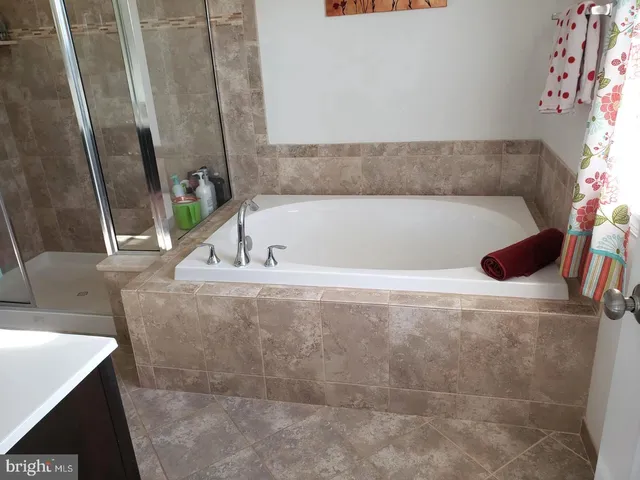 a bathroom with a bathtub and a sink
