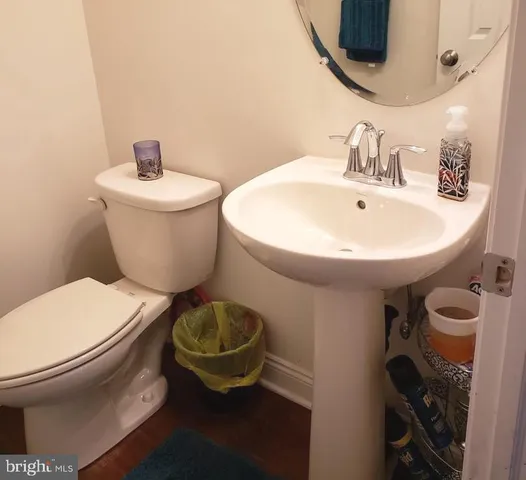 a bathroom with a toilet a sink and a mirror