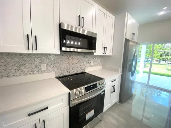 a kitchen with a stove and a microwave