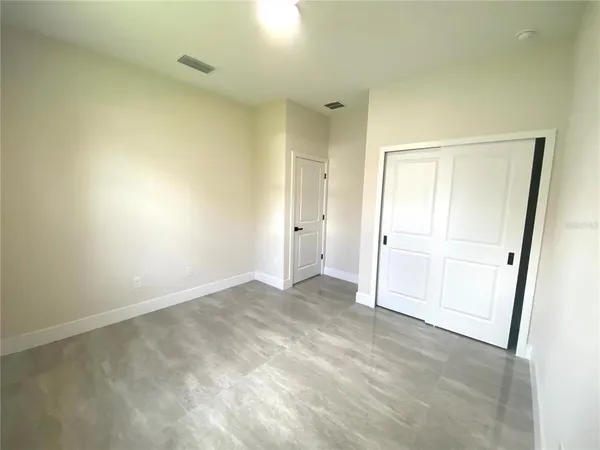 an empty room with closet area