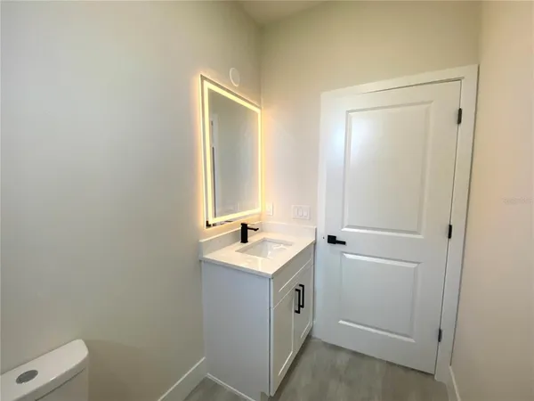 a bathroom with a sink toilet and vanity