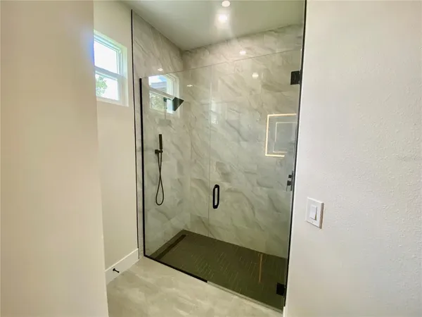 a bathroom with a glass shower door