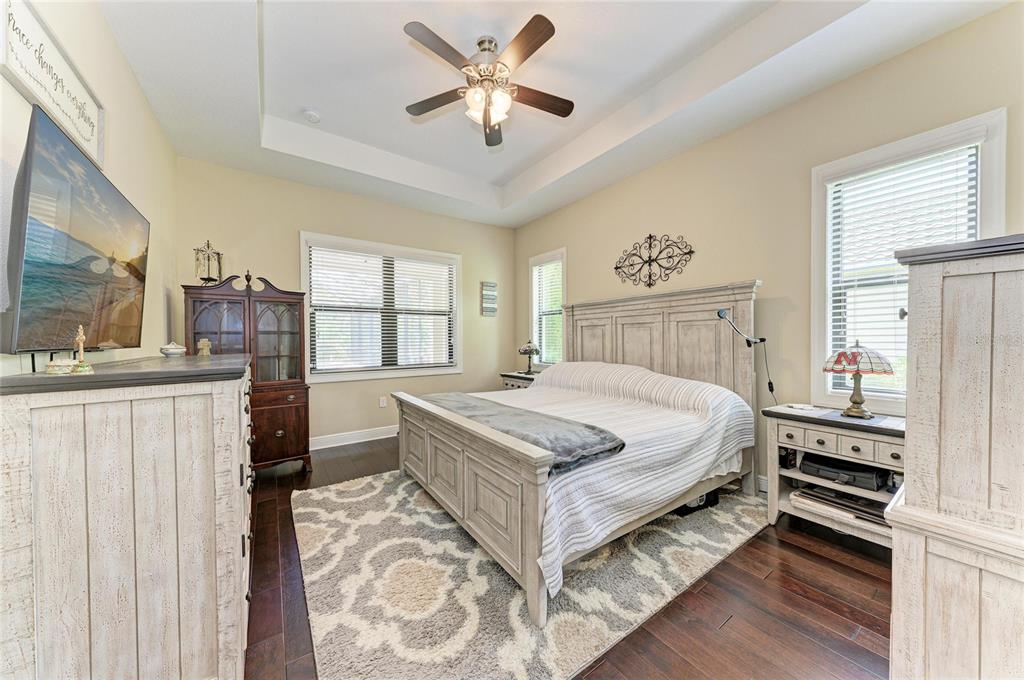 12642 Harney Street Venice, FL 34293 - Photo 22 of 85 a bed sitting in a bedroom next to a window