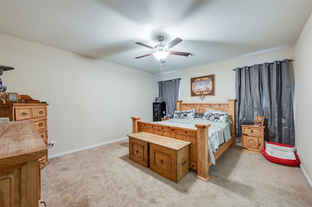 1832 Tyne Way Crowley, TX 76036 - Photo 15 of 25 a bed room with a bed and a chandelier