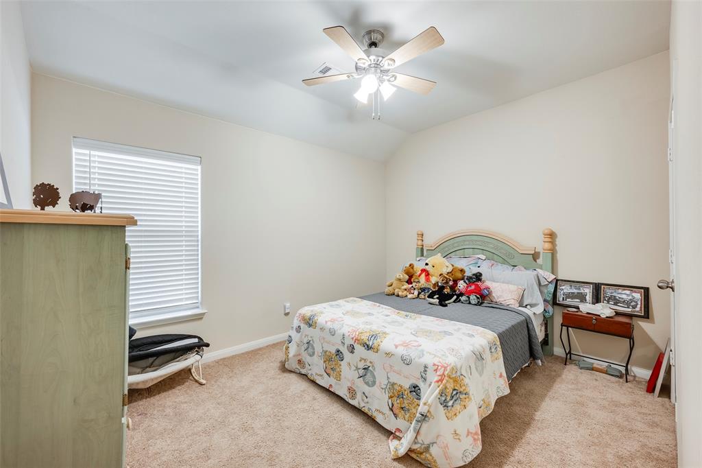 1832 Tyne Way Crowley, TX 76036 - Photo 19 of 25 a bedroom with a bed and a chandelier