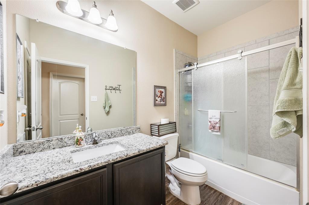 1832 Tyne Way Crowley, TX 76036 - Photo 20 of 25 a bathroom with a granite countertop sink toilet and shower
