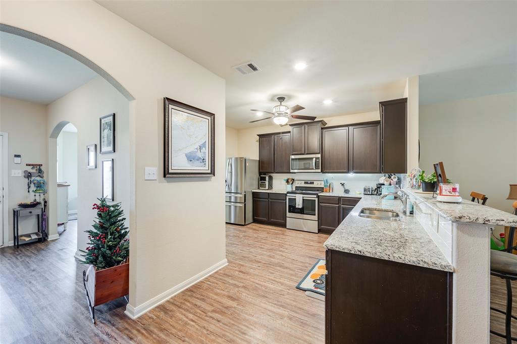1832 Tyne Way Crowley, TX 76036 - Photo 7 of 25 a kitchen with sink cabinets and wooden floor