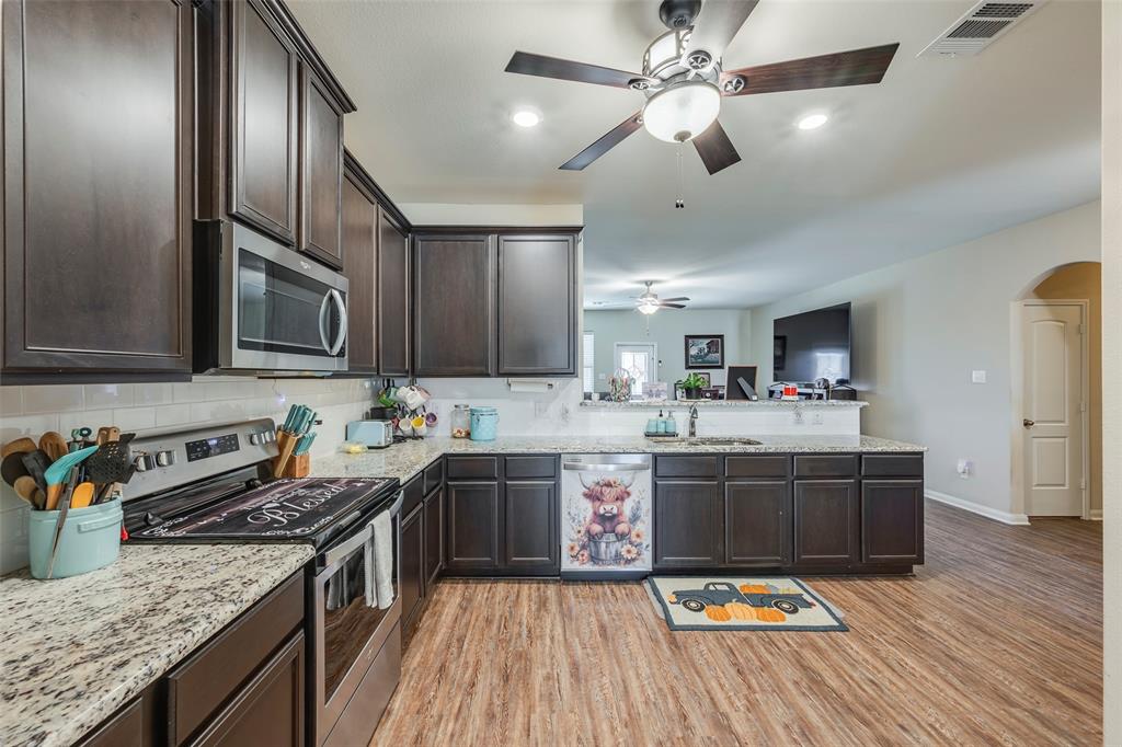 1832 Tyne Way Crowley, TX 76036 - Photo 9 of 25 a kitchen with stainless steel appliances granite countertop a sink stove and refrigerator