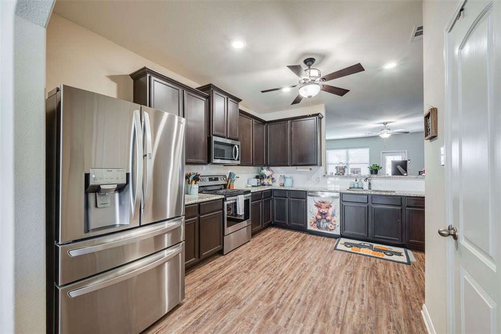 1832 Tyne Way Crowley, TX 76036 - Photo 10 of 25 a kitchen with a refrigerator and a stove top oven