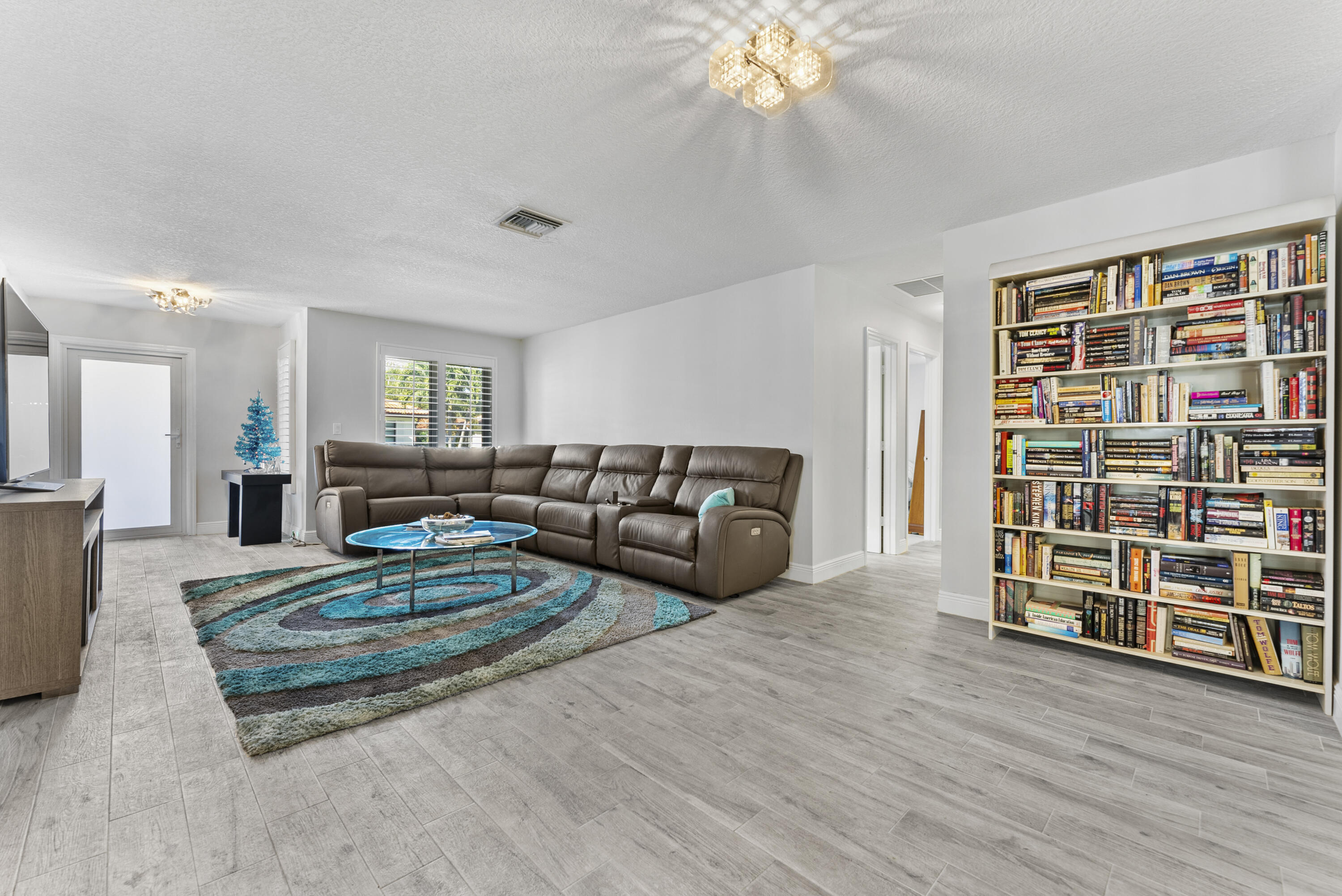 334 Northwest 42nd Street Boca Raton, FL 33431 - Photo 12 of 48 a living room with furniture and a book shelf