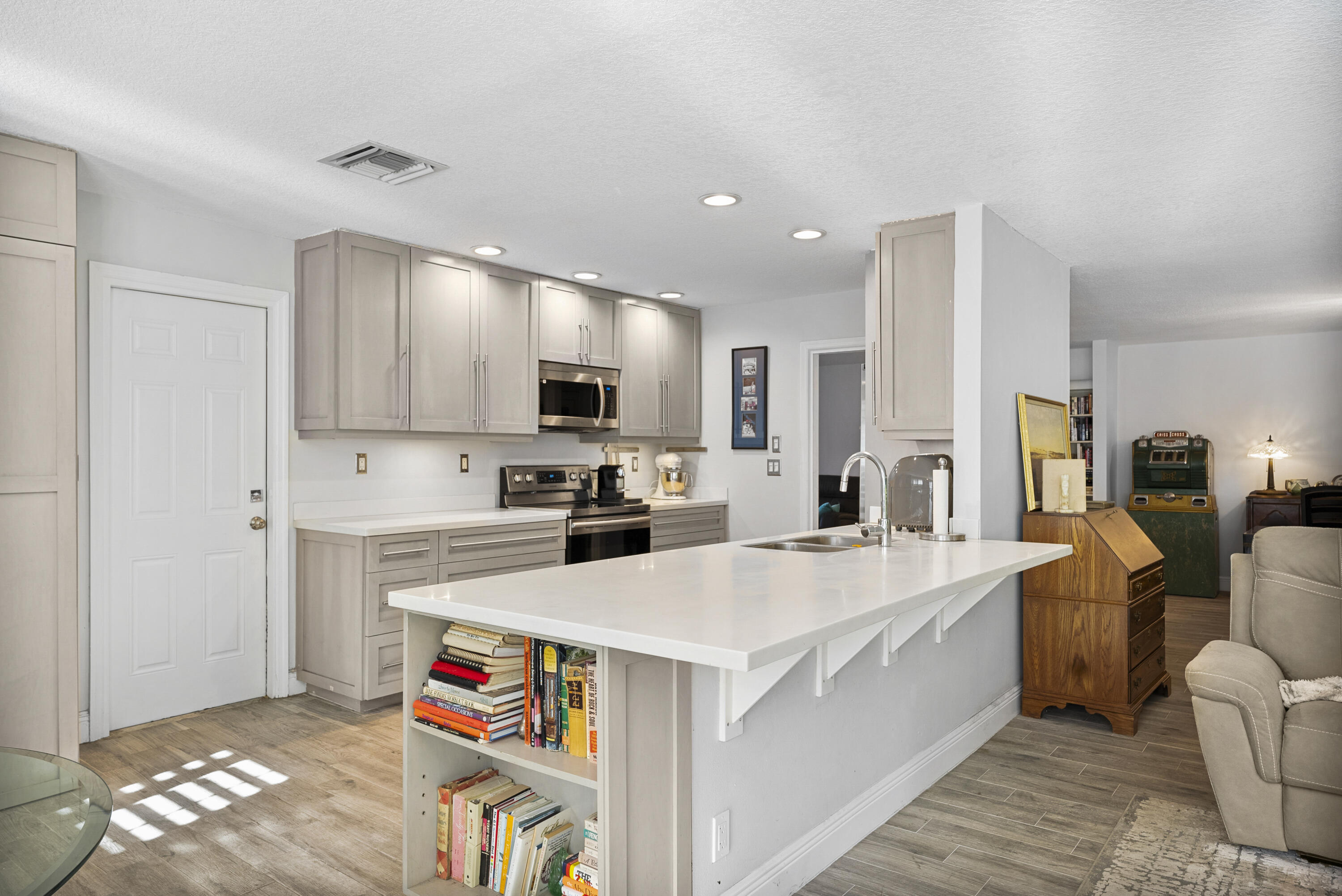 334 Northwest 42nd Street Boca Raton, FL 33431 - Photo 23 of 48 a large white kitchen with sink stove and white cabinets