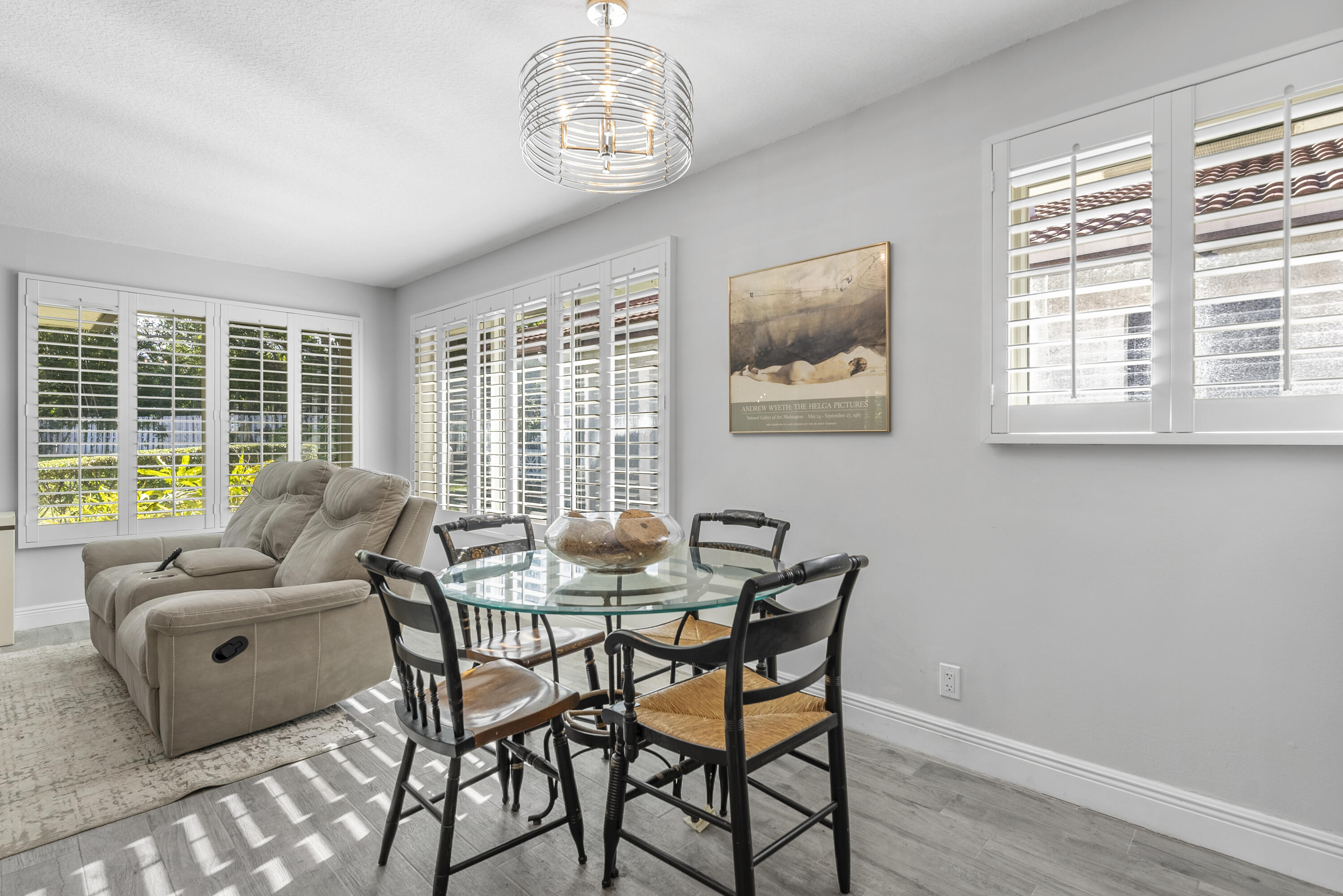 334 Northwest 42nd Street Boca Raton, FL 33431 - Photo 25 of 48 a dining room with furniture a chandelier and wooden floor