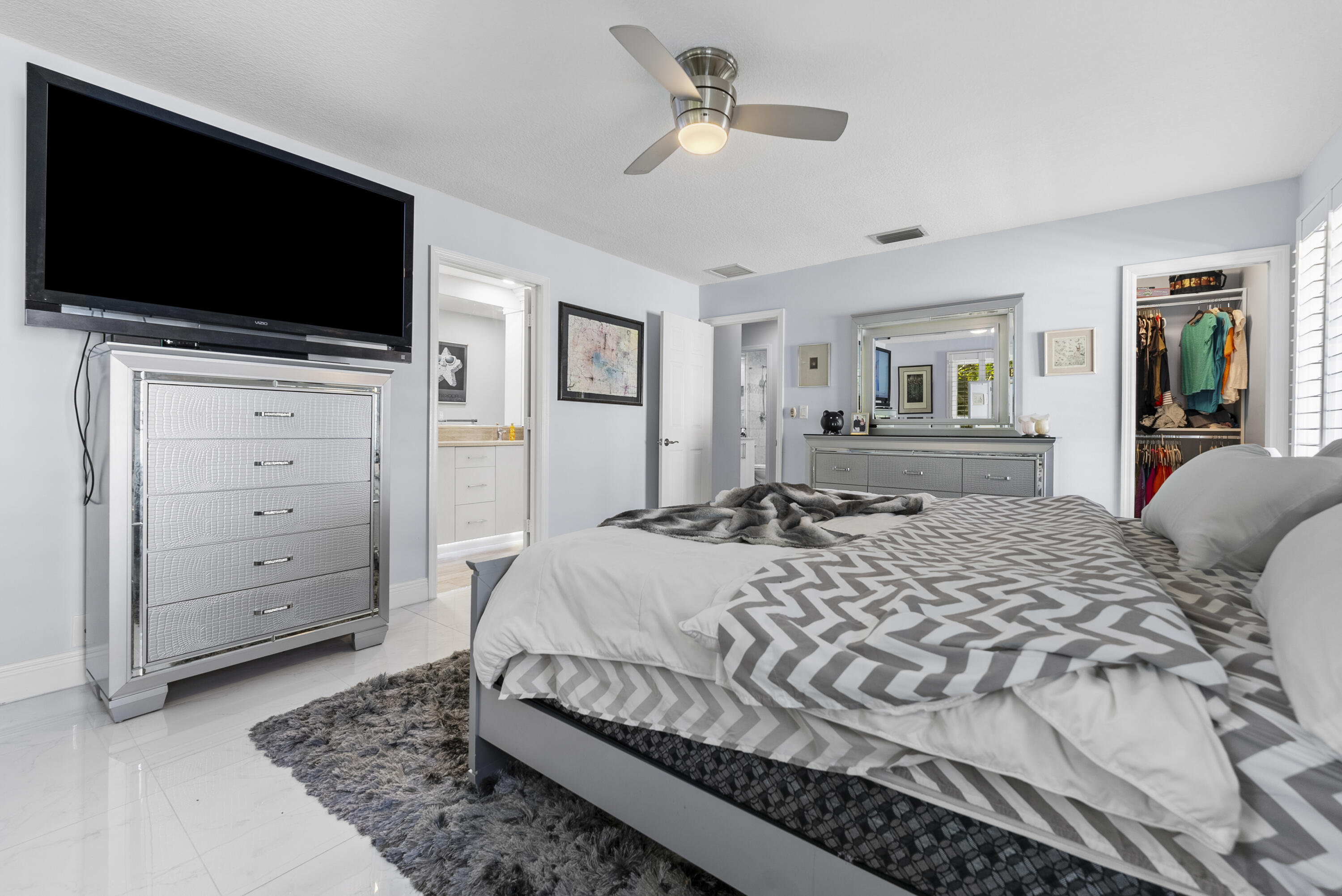 334 Northwest 42nd Street Boca Raton, FL 33431 - Photo 28 of 48 a bedroom with a bed and a flat screen tv