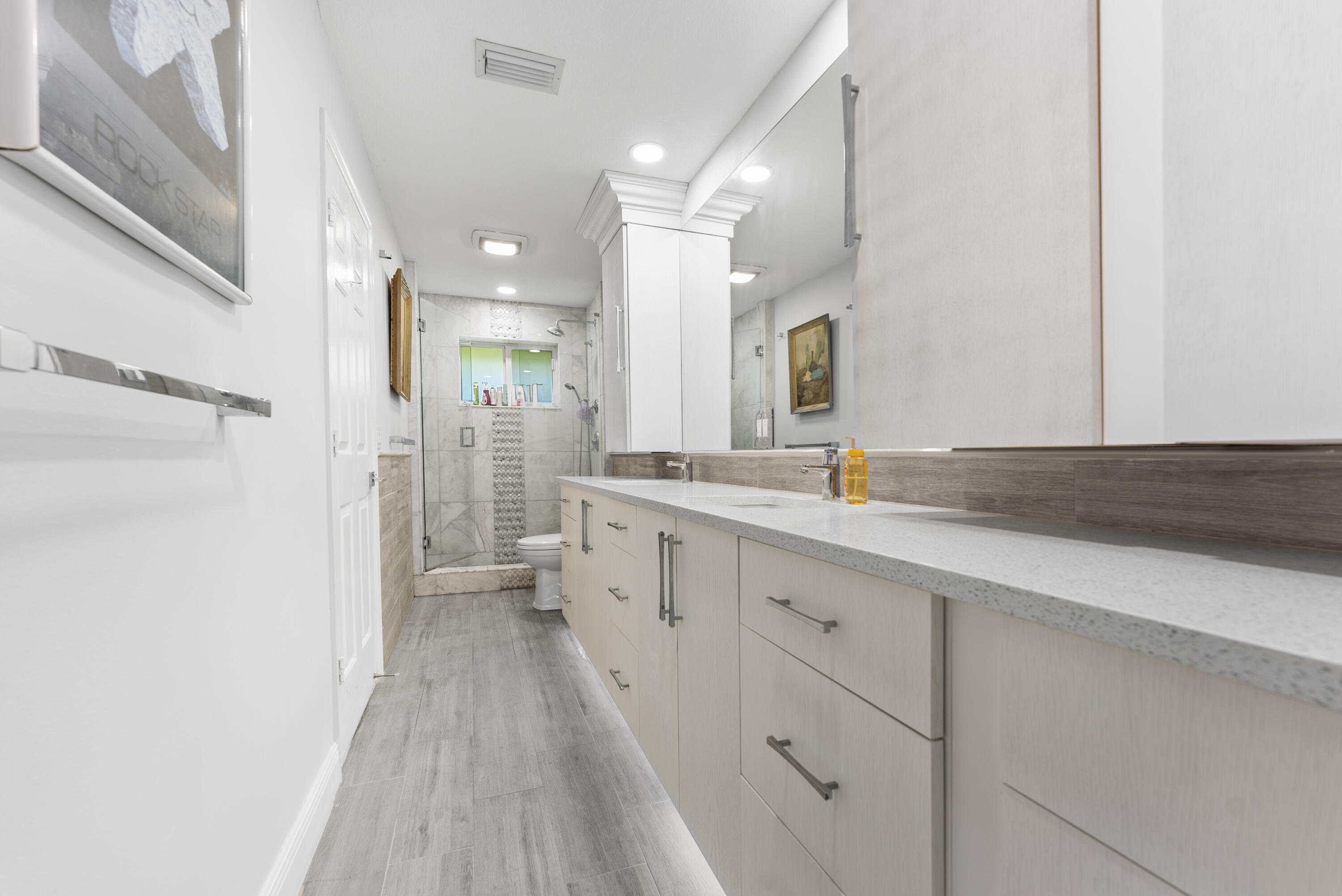 334 Northwest 42nd Street Boca Raton, FL 33431 - Photo 31 of 48 a bathroom with a sink a toilet a shower and a mirror