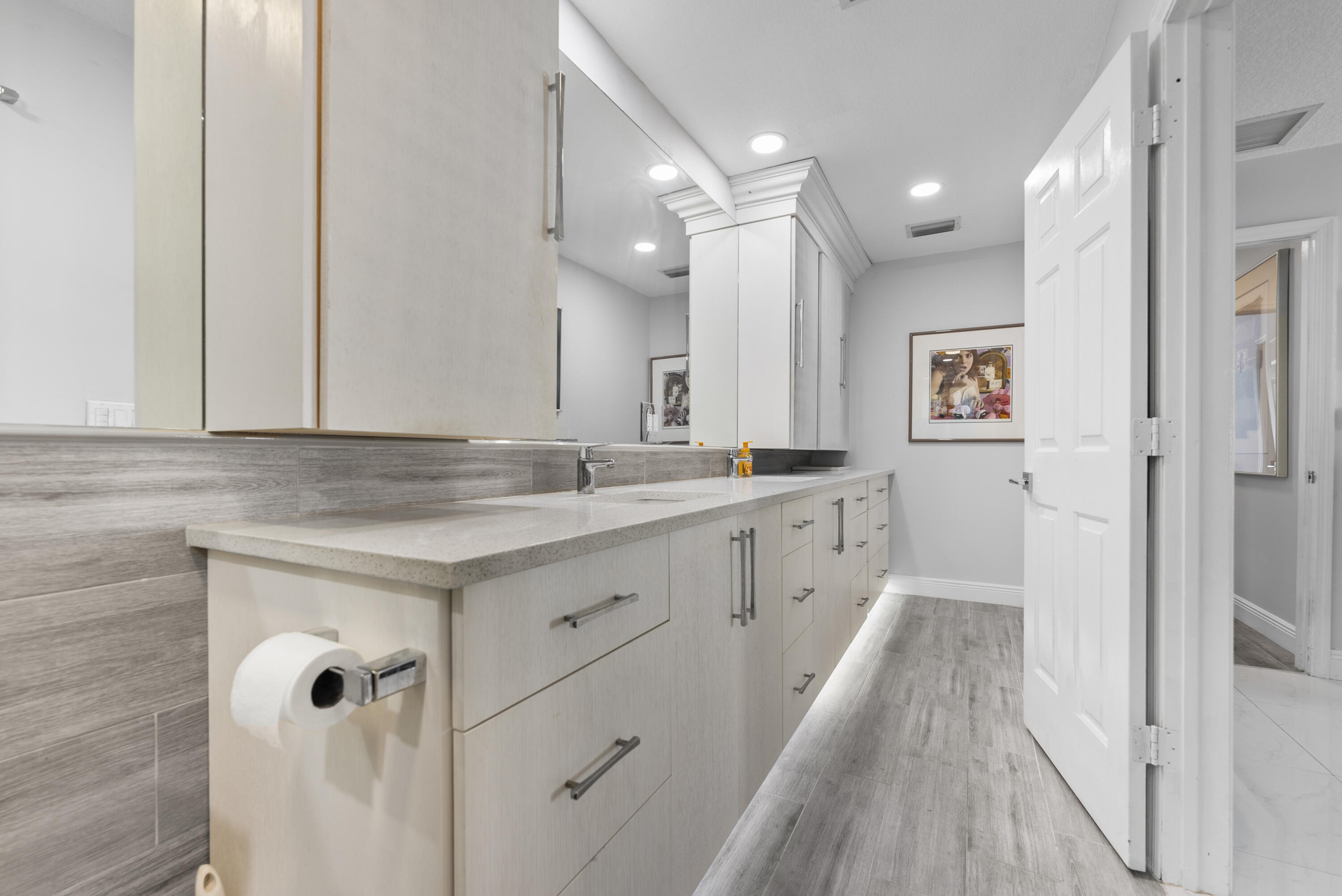 334 Northwest 42nd Street Boca Raton, FL 33431 - Photo 32 of 48 a spacious bathroom with a granite countertop sink a mirror and a bathtub
