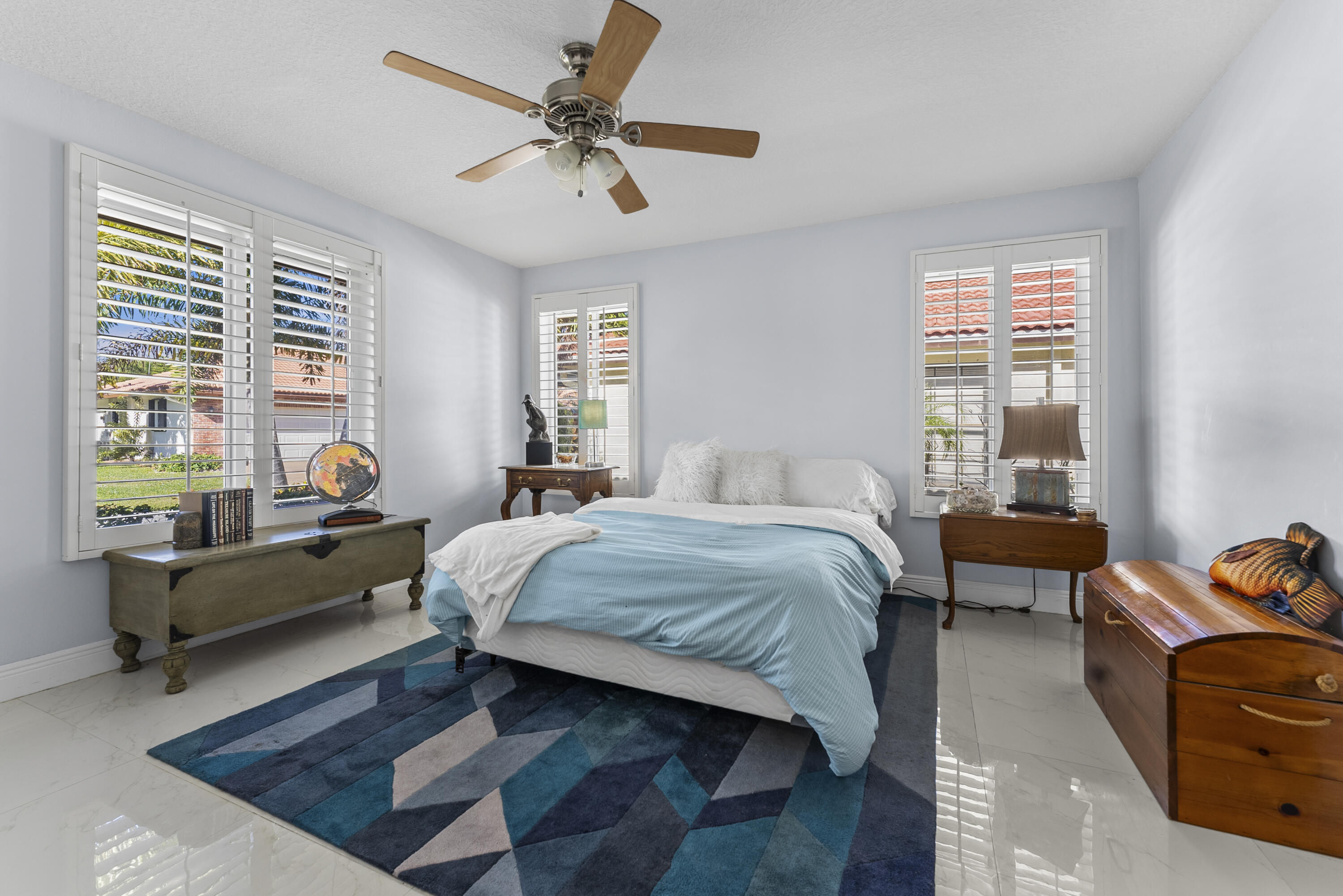 334 Northwest 42nd Street Boca Raton, FL 33431 - Photo 33 of 48 a spacious bedroom with a bed a couch and a window