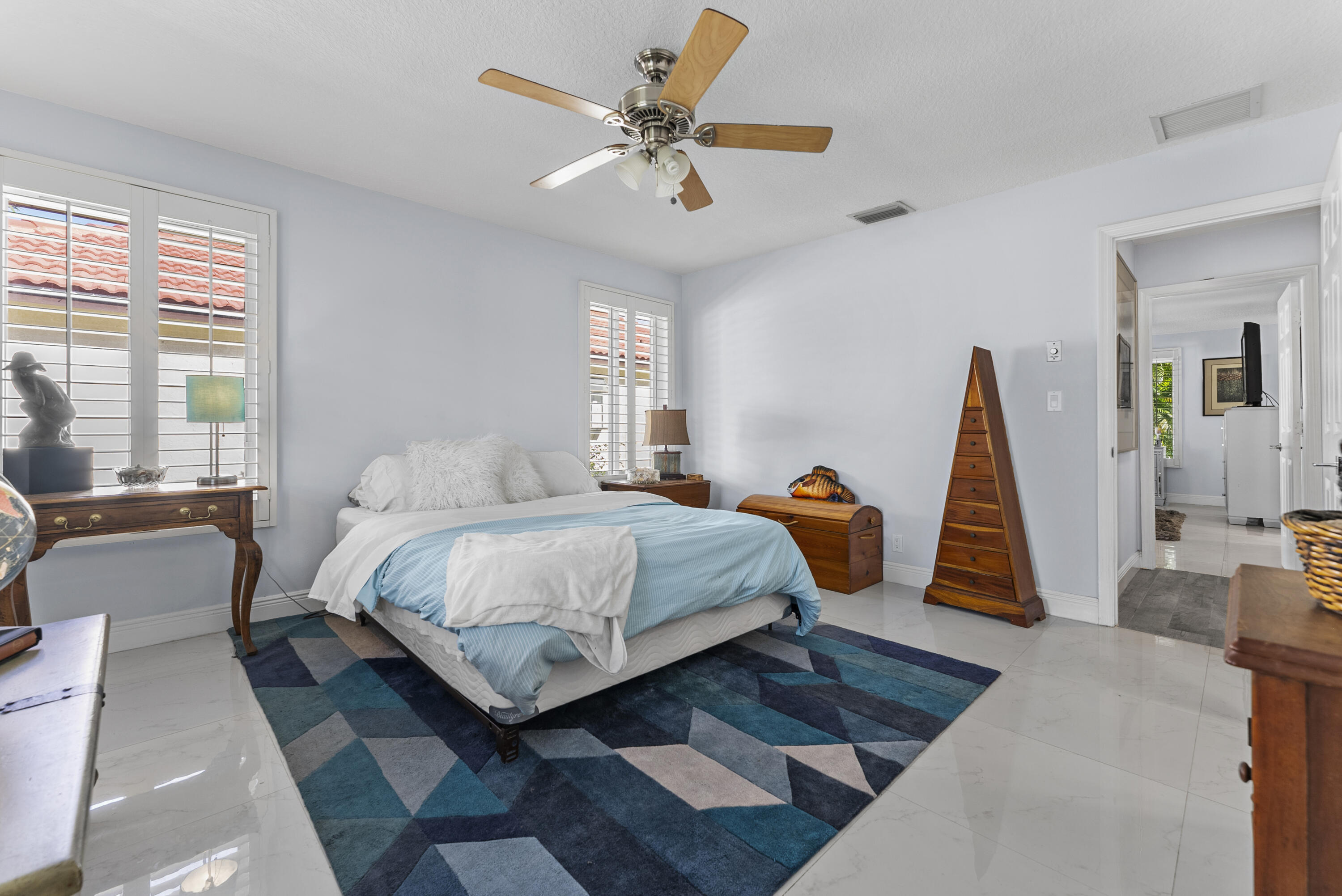 334 Northwest 42nd Street Boca Raton, FL 33431 - Photo 34 of 48 a bedroom with a bed a couch and a chandelier